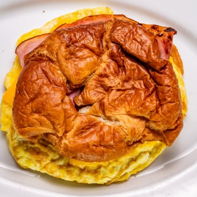 Croissant with Scrambled Egg, American Cheese, Bacon & Ham.